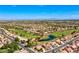Beautiful aerial view of a golf course community, showcasing lush greenery and a pond, with city views at 2740 Billy Casper Dr, Las Vegas, NV 89134