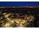 An aerial view of the clubhouse featuring a large parking lot, landscaping and Spanish architectural design at 2740 Billy Casper Dr, Las Vegas, NV 89134