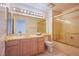 Nicely decorated bathroom with a large mirror and tub with glass doors at 2740 Billy Casper Dr, Las Vegas, NV 89134