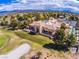 Beautiful building with a tile roof, arched entryway, and a backyard overlooking a well-kept golf course at 2740 Billy Casper Dr, Las Vegas, NV 89134