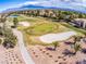 Picturesque golf course view with manicured green, white sand traps, mature landscaping, and beautiful desert architecture at 2740 Billy Casper Dr, Las Vegas, NV 89134