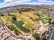 Beautiful aerial shot of the golf course featuring multiple pristine green fairways and tranquil water hazards at 2740 Billy Casper Dr, Las Vegas, NV 89134