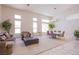 Bright living room features high ceilings, many windows, and adjacent dining area, ideal for entertaining at 2740 Billy Casper Dr, Las Vegas, NV 89134