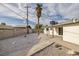 Backyard has gravel landscaping, a covered patio, concrete perimeter, and a large palm tree at 2905 Dogwood Ct, North Las Vegas, NV 89030