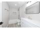 Modern bathroom features white subway tile, gold fixtures and updated vanity at 2905 Dogwood Ct, North Las Vegas, NV 89030