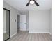 Bright bedroom features new floors, a ceiling fan, and closet with sliding doors at 2905 Dogwood Ct, North Las Vegas, NV 89030