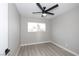 Bright bedroom features new floors, a ceiling fan, and a window with natural light at 2905 Dogwood Ct, North Las Vegas, NV 89030