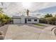 This single-story home features a xeriscaped front yard and a long, paved driveway at 2905 Dogwood Ct, North Las Vegas, NV 89030