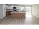 Bright, remodeled kitchen with white and wood cabinets, stainless steel appliances, and a large island at 2905 Dogwood Ct, North Las Vegas, NV 89030