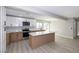 Open kitchen featuring new stainless steel appliances, an island, and plenty of natural light at 2905 Dogwood Ct, North Las Vegas, NV 89030
