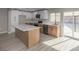 Bright kitchen with an island, stainless appliances, white countertops, and modern cabinets at 2905 Dogwood Ct, North Las Vegas, NV 89030