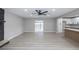 Open living space with gray walls, wood floors, fireplace, and view into the modern kitchen at 2905 Dogwood Ct, North Las Vegas, NV 89030