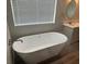 Bathroom featuring freestanding tub, marble countertop and oval mirror at 3016 Mount Charleston Dr, Pahrump, NV 89048
