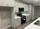 Sleek kitchen with stainless appliances, white cabinets, and quartz counters at 3016 Mount Charleston Dr, Pahrump, NV 89048