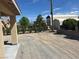 Spacious backyard with mature trees and rear shed behind a fence at 3016 Mount Charleston Dr, Pahrump, NV 89048