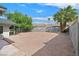 Spacious backyard with low-maintenance gravel landscaping, mature trees, and a block wall fence at 3124 Glenhurst Dr, Las Vegas, NV 89121