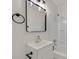 Bathroom featuring a modern black framed mirror, white vanity and shower/tub combo with white tiling at 3124 Glenhurst Dr, Las Vegas, NV 89121