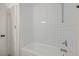 Bright bathroom showcases a white tiled shower and bathtub combination with modern fixtures at 3124 Glenhurst Dr, Las Vegas, NV 89121