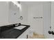 Bathroom with a black countertop and modern fixtures at 3124 Glenhurst Dr, Las Vegas, NV 89121