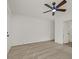 Bright bedroom featuring laminate flooring, a ceiling fan, and freshly painted white walls at 3124 Glenhurst Dr, Las Vegas, NV 89121