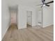 Spacious bedroom featuring light laminate flooring and freshly painted white walls at 3124 Glenhurst Dr, Las Vegas, NV 89121