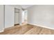 This bedroom includes wood-look flooring and a closet with white sliding doors at 3676 Renovah St # 102, Las Vegas, NV 89129