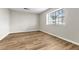 A bright bedroom features laminate flooring and a large window at 3676 Renovah St # 102, Las Vegas, NV 89129