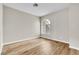 Bright bedroom features wood-look flooring and a large arched window, providing natural light at 3676 Renovah St # 102, Las Vegas, NV 89129