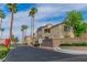 Sunhampton gated community entrance with palm trees lining the driveway at 3676 Renovah St # 102, Las Vegas, NV 89129