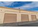 A row of garages showcasing individual doors and unit numbers, emphasizing parking availability at 3676 Renovah St # 102, Las Vegas, NV 89129