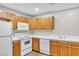 Bright kitchen with white countertops and wood cabinets, and modern appliances at 3676 Renovah St # 102, Las Vegas, NV 89129