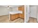 Cozy kitchen with wood cabinets and white countertops flows into living area at 3676 Renovah St # 102, Las Vegas, NV 89129