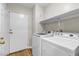 Convenient laundry room with washer, dryer, and storage shelf at 3676 Renovah St # 102, Las Vegas, NV 89129