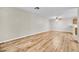 Spacious living room featuring modern wood flooring and neutral wall paint at 3676 Renovah St # 102, Las Vegas, NV 89129