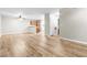 Open-concept living room features wood-look floors, ceiling fan and views of the kitchen at 3676 Renovah St # 102, Las Vegas, NV 89129