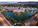Aerial view of community, showcasing a scenic lake and surrounding neighborhood with mature trees at 3846 W Neal Ave, Las Vegas, NV 89141