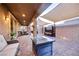 Beautiful covered patio with a cozy seating area and a stone fire pit, perfect for relaxing evenings at 3846 W Neal Ave, Las Vegas, NV 89141