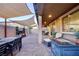 Relaxing backyard with covered patio, a built-in fire pit, and comfortable seating, ideal for outdoor living at 3846 W Neal Ave, Las Vegas, NV 89141