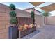 Inviting backyard featuring a decorative water feature and lush landscaping with privacy wall at 3846 W Neal Ave, Las Vegas, NV 89141
