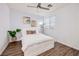 Bright bedroom with modern decor, including a platform bed and wood-look flooring at 3846 W Neal Ave, Las Vegas, NV 89141