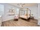 Cozy bedroom featuring wood-look floors, a ceiling fan, and a four-poster bed at 3846 W Neal Ave, Las Vegas, NV 89141