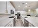 Bright kitchen features white cabinetry, stainless steel appliances, and quartz countertops at 3846 W Neal Ave, Las Vegas, NV 89141