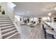 Open-concept living space with modern fireplace, staircase, and lots of natural light at 3846 W Neal Ave, Las Vegas, NV 89141