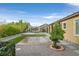 A serene backyard oasis featuring a pergola, desert landscaping, and lush greenery at 3870 Valles Caldera Ct, Las Vegas, NV 89118