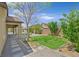 The backyard showcases a lush lawn, mature trees, covered patio and outdoor living space at 3870 Valles Caldera Ct, Las Vegas, NV 89118