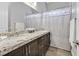 Bathroom featuring double sinks, granite countertop, and a shower with curtain at 3870 Valles Caldera Ct, Las Vegas, NV 89118