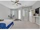 This large bedroom has a ceiling fan, large windows, and built-in desk and storage at 3870 Valles Caldera Ct, Las Vegas, NV 89118