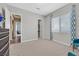Bedroom featuring carpet floors, window, and mid-century modern furnishings at 3870 Valles Caldera Ct, Las Vegas, NV 89118