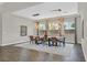 Elegant dining room with modern lighting, dining table, and ample natural light from large windows at 3870 Valles Caldera Ct, Las Vegas, NV 89118