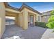 Charming front entry with covered portico offers stylish curb appeal with desert landscaping at 3870 Valles Caldera Ct, Las Vegas, NV 89118
